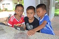 Three boys are watching the interest at a telephone.